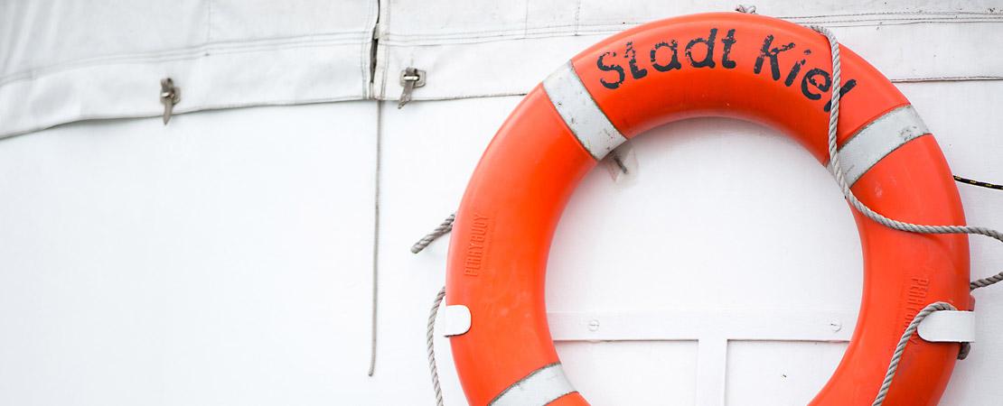 Rettungsring an Bordwand mit Aufschrift "Stadt Kiel"